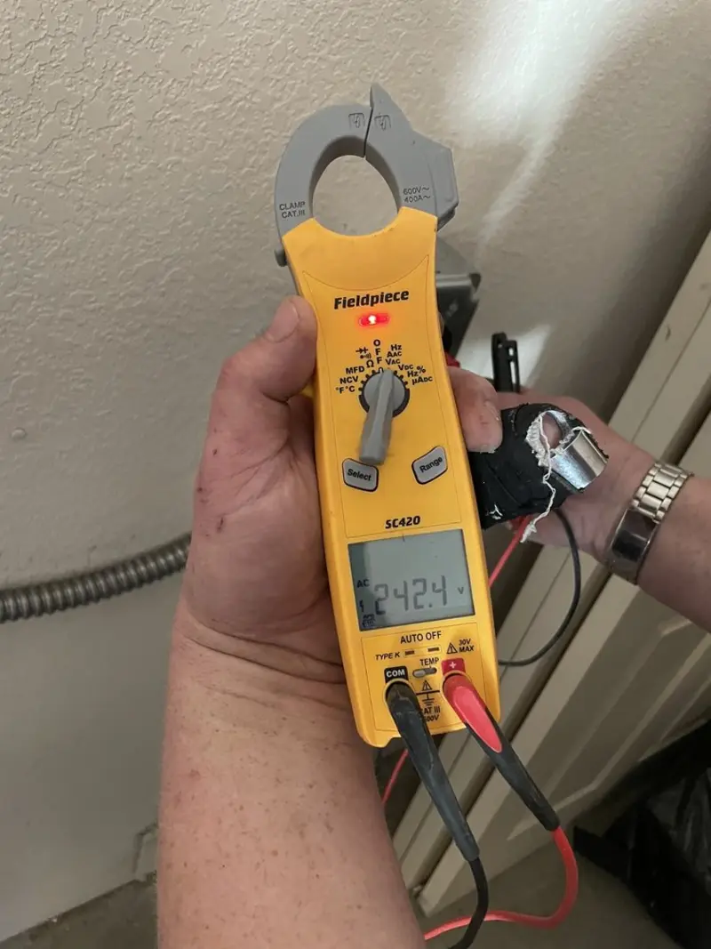 Voltage testing with clamp meter during Recessed Lighting Installation in Kansas City